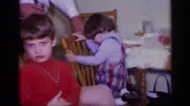 California USA (1969): Family Sitting Around With Kids Standing Next To Them