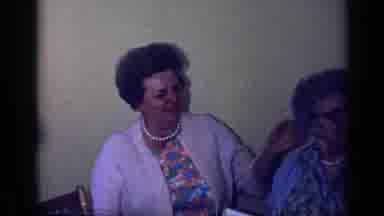 California USA (1969): A Lady Fixes An Older Ladies Hair As We See People Enjoying