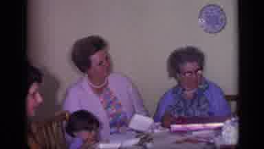 California USA (1969): People Sitting Around A Table Opening Presents And Talking
