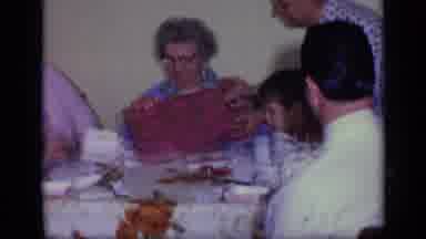 California USA (1969): Woman Wearing Blue Dress Receives Red Gift Box From Woman