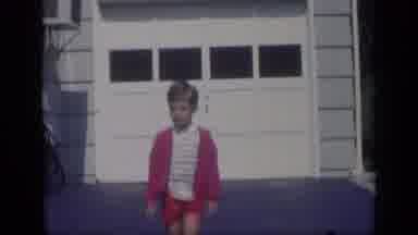 California USA (1969): Boy Wearing Red Shorts And Sweater Walks Away From White