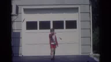 California USA (1969): Boy Wearing Red Shorts And Sweater Walks Away From White