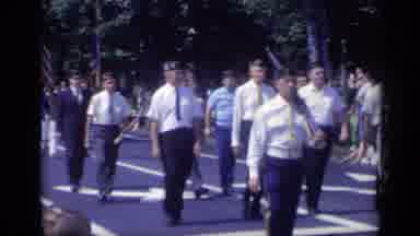 California USA (1969): People In Uniforms Marching In Unison Holding Flags