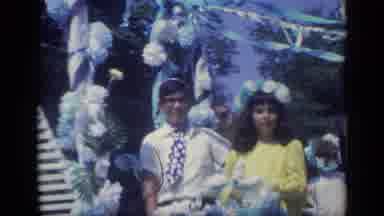 CALIFORNIA USA-1969: Low Angle People Riding On A Flower-Decorated Parade Float And Truck