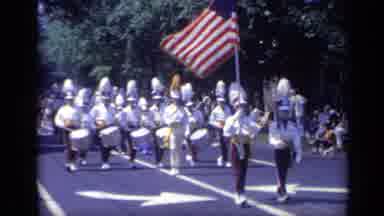 California USA (1969): Marching Band Drums In City Streets During Parade For