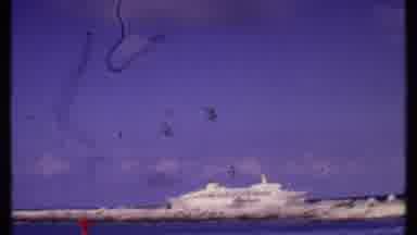 Bahamas (1969): Fuming Plane In Flight Over A Coastal City In The Years Of