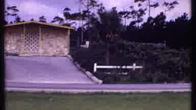 Bahamas (1969): Lady Sitting Outside In Tropical Breeze On A City Street