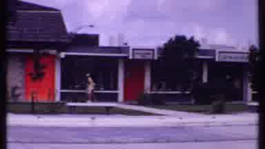 Bahamas (1969): A Few People Pass In Front Of An Abandoned Or Closed Strip Mall