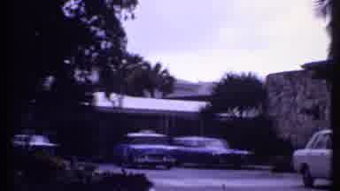 Bahamas-1969: Cab Emerges From Under Carport And Person Walks Toward Entrance Of