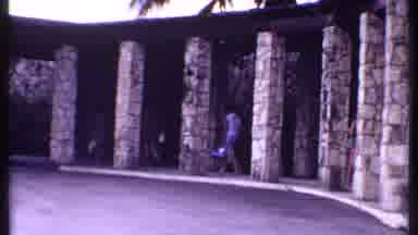 Bahamas (1969): People Walking With Suitcases Under A Roof With Palm Trees