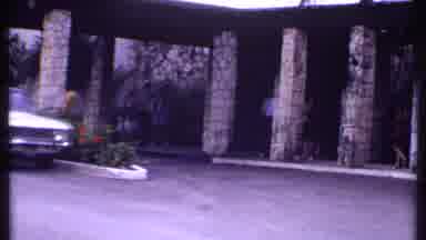 Bahamas (1969): People Walk On Walkway In Front Of Building Then Boat Speeds Away