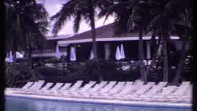 Bahamas (1969): Panoramic Shot Of Resort Pool Showing Empty Patio Chairs And Staff