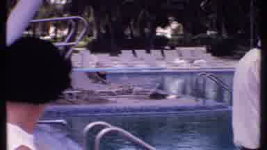 Bahamas (1969): Woman And Man Are Outside Next To A Pool Then The Man Is Focused