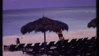 Bahamas (1969): A Beach With Lots Of Beach Chair With Only A Few People And Two