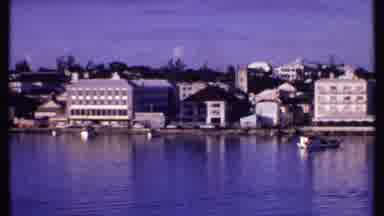 Bahamas (1969): Several Boats Float In A River That Is Lined With Buildings