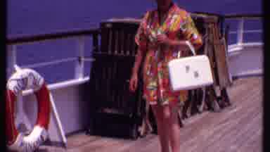Bahamas (1969): A Lady In A Bright Floral Bathrobe Stands On A Cruise Ship Deck