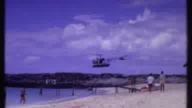 Bahamas (1969): Helicopter Fly Over A Crowded Beach On A Cloudy Day