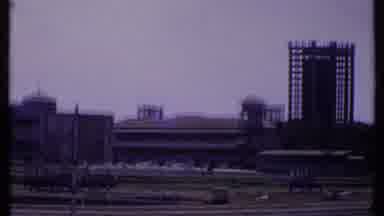 India (1969): Many Low Buildings With One Taller Building And A Sign During The