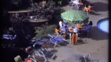 India (1969): Two People Sit Beneath Green Umbrella Before Shot Shows The Rest Of