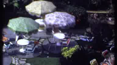 India (1969): Camera Captures The Patio Filled With Chairs Tables And Umbrellas