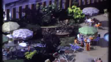 India (1969): People Sitting Poolside On A Sunny Day While A Man Gets Out Of The