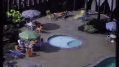 India (1969): People Lounge In Recliners Under Colored Umbrellas Attached To