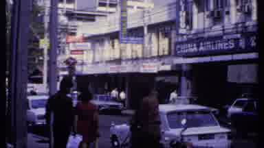 India (1969): A Man With Glasses Smoking A Pipe Observes The City Center Many Cars