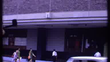 India (1969): Man Looks Up As He Stands Across From Entrance To Sheraton Bangkok