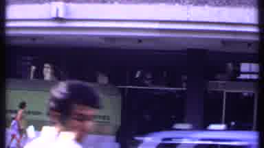 India (1969): Old Footage Of A Busy Street Shows A Mother And Her Son Entering A