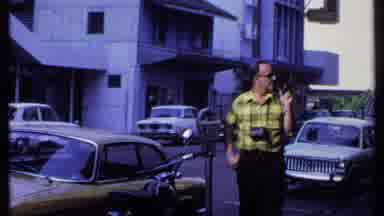 India (1969): Man With Camera Hanging On His Neck Looks Around As Camera Captures