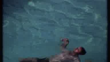 India (1969): Man Swimming On His Back In Pool Then People Sitting On Chairs By