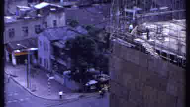 India (1969): Two People Walking Down Empty Sidewalk On A Clear Day