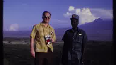 Kenya (1969): Two Men Stand On A Hill Over A Valley On A Windy Day Then A The