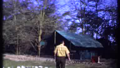 Kenya (1969): Man Wearing A Yellow Shirt Walks Towards A Park Shelter