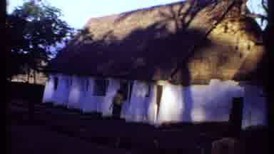 Kenya (1969): A Man In A Yellow Shirt Walks Down The Sidewalk Behind A Large