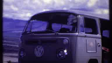 KENYA-1969: Man Approaches Open VW Bus Door Then Elephant Grazes in Savanna