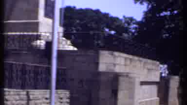 Kenya (1969): A Man Is Standing In A Park Next To A Monument With A Large Field