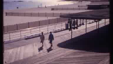 New London Connecticut (1969): Slow Motion Two People Walking On A Boardwalk