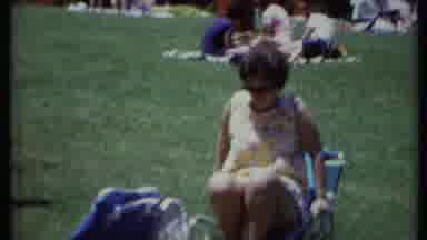 California USA (1971): Woman Getting Up Out Of A Lawn Chair With Other Sinners In