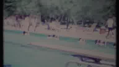 California USA (1971): Groups Of People Sitting Around And Swimming In A Very