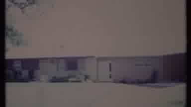 California USA (1971): A Very Large Light Colored Home With Green Trees In The