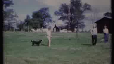California USA (1971): Four People In Yard By Barn One Waves Toward Camera Dog
