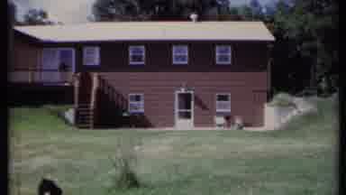 California USA (1971): A Pan Of A Family Home And A Snippet Of A Caravan