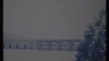California USA (1971): Cars Driving On A Pier Going Out Into The Water