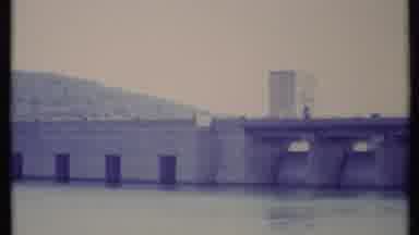 California USA (1971): Bridge Crossing Over Water Being Filmed From Across With