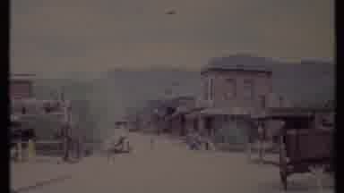 California USA (1971): A Cart Stands Alone On A Dirt Road That Runs Through An