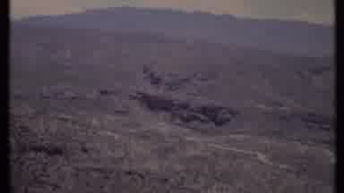 California USA (1971): Desert Landscape With Brown Mountains And A Dark Hole Among
