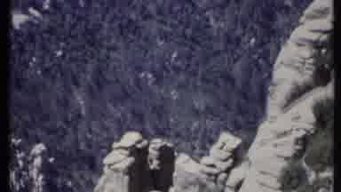 California USA (1971): Huge Open Field Below With Trees Below With Person Filming