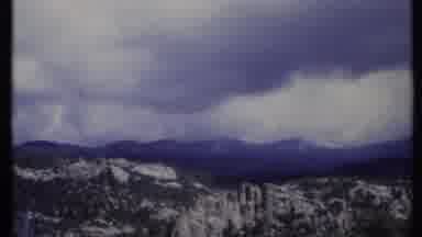 California USA (1971): Two Different Views Of Snow Covered Mountains On A Cloudy