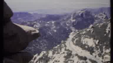 California USA (1971): A Rocky Mountains Covered On Rich Forest With Roads On Its